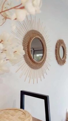 two mirrors on the wall above a table