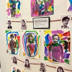 several children's portraits are displayed on the wall