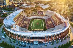 an aerial view of the football stadium with sun shining on it's roof and field