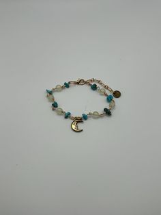 Hand-crafted bracelet made with turquoise beads, glass beads, gold colored wire, and a metal moon charm. Bracelet is adjustable from 7 to 9 inches. Metal moon charm measures 1/2 inches by 3/8 inches. Handmade Boho Jewelry, Bead Wire, Homemade Jewelry, Bracelet Beaded, Moon Charm, Wire Bracelet, Dream Jewelry, Turquoise Beads, Fit Inspo