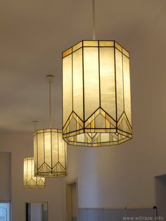 three lamps hanging from the ceiling in a room