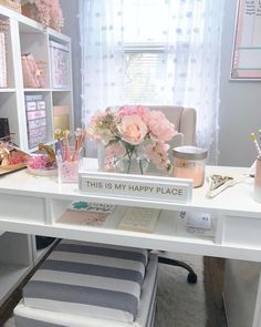 a white desk topped with lots of pink flowers and writing on the top of it