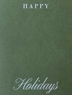 a green book with the words happy holidays written in white on it's cover