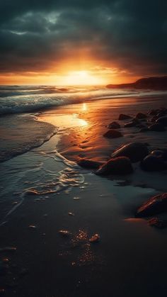 the sun is setting over the ocean with rocks in the foreground and dark clouds above