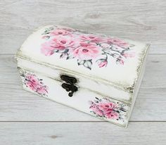 a white box with pink flowers painted on it