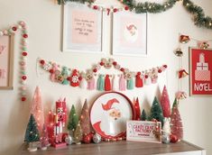 christmas decorations are displayed on the wall above a dresser