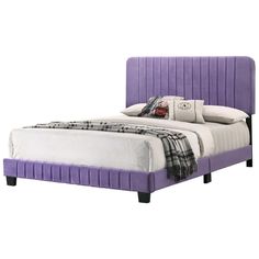 a bed with purple upholstered headboard and pillows on top of the mattress