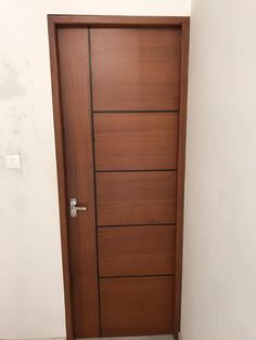 the door is made of wood and has five drawers on each side, along with a white wall