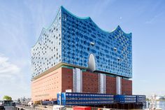 a large blue building sitting on the side of a road next to a parking lot