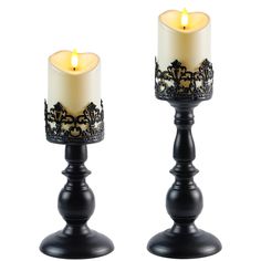 two black candles sitting next to each other