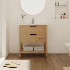 a bathroom with white walls and wooden floors