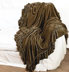 a bed with a blanket on top of it