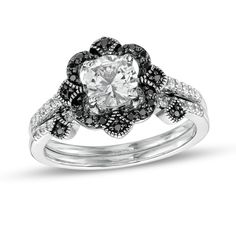 Display your unique romance with this eye-catching bridal set. Fashioned in sterling silver, the tiara-inspired engagement ring showcases a 6.0mm shimmering white lab-created sapphire. Quartets of black enhanced diamonds surround the center stone while single black enhanced diamonds in milgrain-lined frames adorn the compass points. Dainty white lab-created sapphires glisten along the shank. The wedding band features black enhanced diamonds in coordinating milgrain-detailed frames and a white la The Compass, White Lab, Peoples Jewellers, Forest Theme, Black Diamond Ring, Theme Wedding, Bridal Tiara, Sapphire Stone, Gemstone Engagement Rings