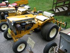 two large yellow tractors parked next to each other