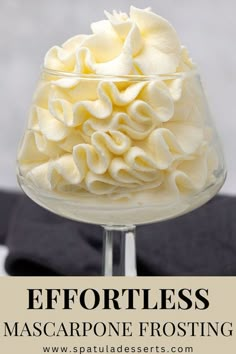 a close up of a dessert in a glass on a table with text overlay that reads effortless mascarpone frosting