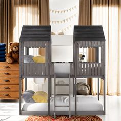 two bunk beds in a room with curtains on the window sill and teddy bear