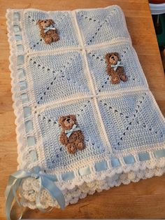 a crocheted blanket with teddy bears on it