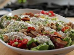 a salad with dressing in a white bowl