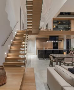 a living room filled with furniture next to a staircase