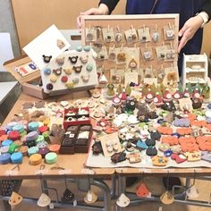 a table topped with lots of different types of buttons and earring hooks on top of wooden boards