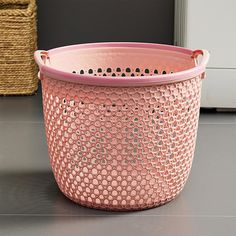 a pink basket sitting on top of a table