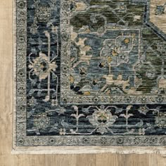 a blue and beige rug with an ornate design