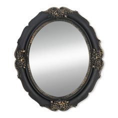 an ornate black and gold mirror on a white wall