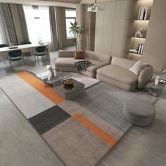 a modern living room with grey couches and orange rugs on the floor in front of large windows