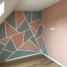 an empty room with pink and grey walls