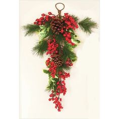 a christmas decoration hanging on the wall with pine cones and red berries, evergreens and holly