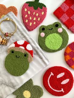 four different shaped rugs and two keychains on top of a white surface