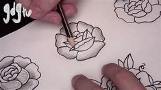 someone is drawing flowers with pencils on paper