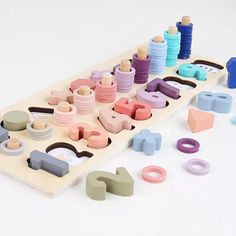 an assortment of wooden toys sitting on top of a table