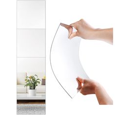 a person holding a piece of paper in front of a white room with a mirror