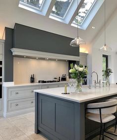 a kitchen with an island and skylights above it