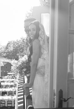 the bride and groom are standing on the porch