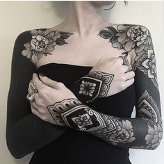 a woman with tattoos on her arm and arms