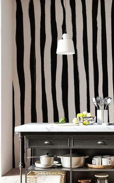 a kitchen with black and white striped wallpaper