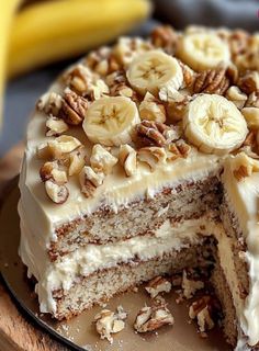 there is a cake with bananas and nuts on the top of it, cut in half