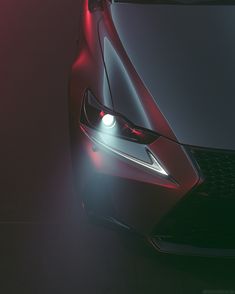 the front end of a car with its lights on