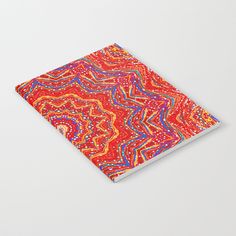 a notebook with an abstract design on the front and back cover, in bright colors