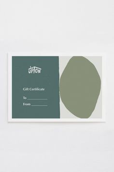 a gift certificate is shown on a white surface with a green circle in the center