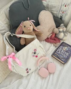 stuffed animals and other items on a bed