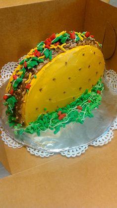 a cake in the shape of a taco on top of a doily plate