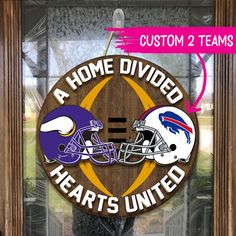 a wooden sign with two football helmets on it that says, a home divided hearts united