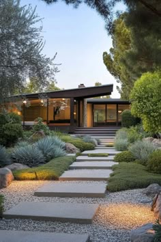 a stone path leading to a modern home