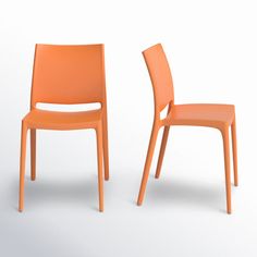 two orange chairs sitting next to each other on a white surface with one chair facing the camera