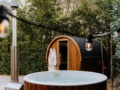 an outdoor jacuzzi tub with lights hanging from it