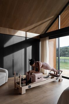 a bed sitting on top of a wooden floor next to a window