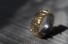 This ring has been press fitted together with brass on the top, and aluminium in the inside. It has then been hand filed all over the top to get that worn look, which catches light and make it look shiny. This is raw brass over the top, which may get slightly duller in colour over time but will still have a shine to it. This ring is built for everyday use and is 100% water proof! The ring in the photos is size 11 1/2 Width 8mm Thickness 2.5mm This ring will be made and sent out to you within a week of your purchase. This ring has a smooth comfort fit that will not turn your finger grey unless it is exposed to harsh chemicals, or sweat over a long period of time.  Aluminium is hypoallergenic so it is safe to wear even for people with sensitive skin. Shiny Rings, Ring Unique, Raw Brass, Over The Top, Water Proof, Rings Statement, Unique Rings, Handmade Ring, Statement Rings